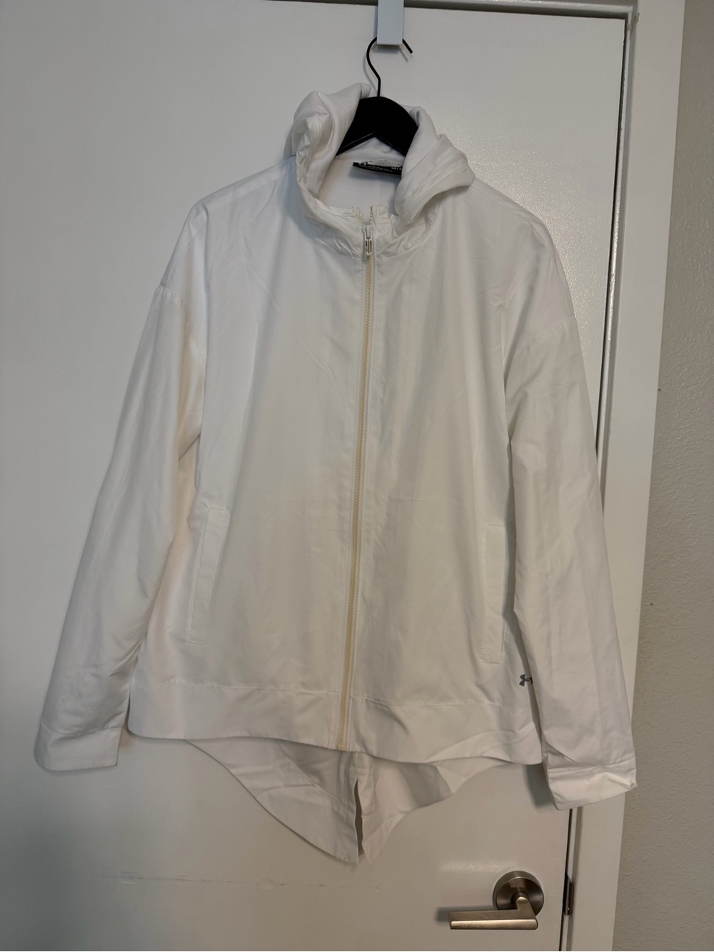 Under Armour hooded windbreaker jacket with a full zip front and a high-low hem